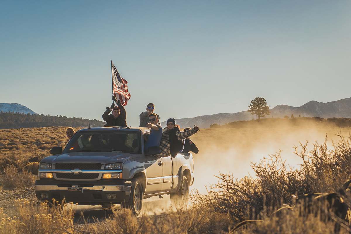united states group of people riding silver Chevrolet extended cab road